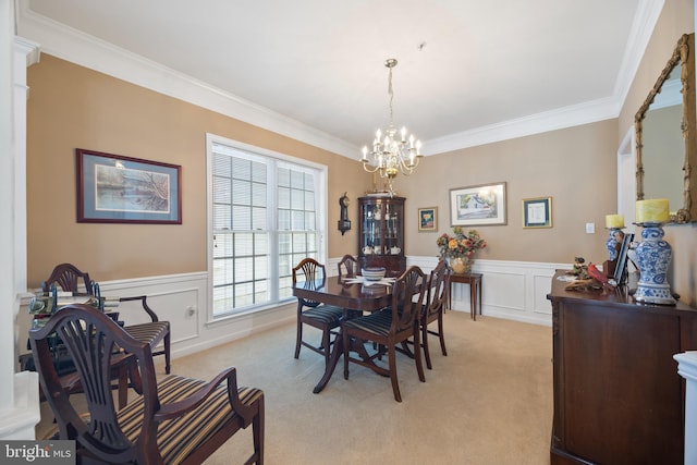 dining space featuring ornamental molding, light carpet, and a notable chandelier