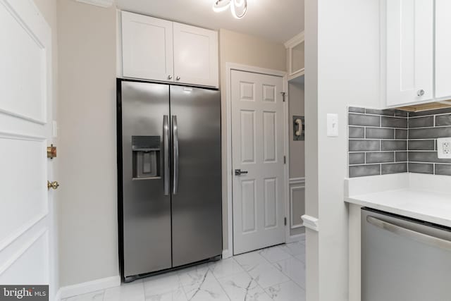 kitchen featuring backsplash, stainless steel appliances, and white cabinetry