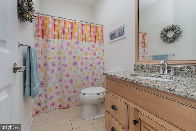 bathroom featuring toilet, vanity, tile patterned flooring, and a shower with shower curtain