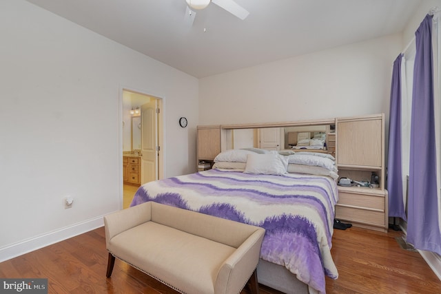 bedroom with ceiling fan, dark hardwood / wood-style floors, and ensuite bath