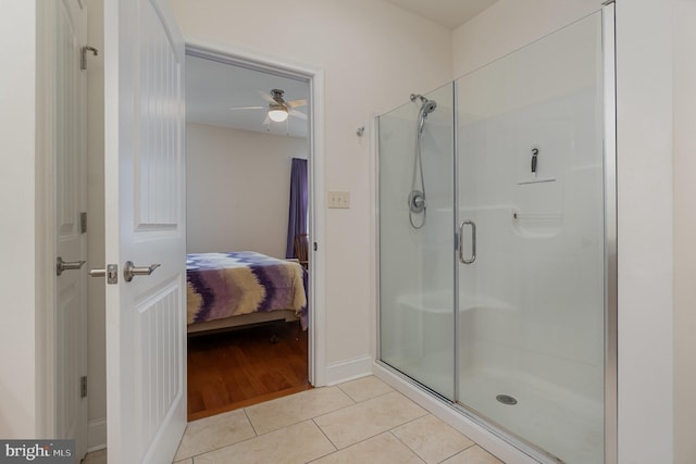 bathroom with ceiling fan, an enclosed shower, and tile patterned floors