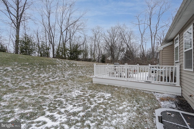 yard layered in snow featuring central air condition unit and a deck