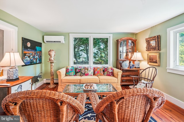 living room with wood-type flooring, baseboard heating, and a wall mounted air conditioner