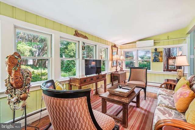 sunroom featuring a wall unit AC, lofted ceiling, and a baseboard radiator