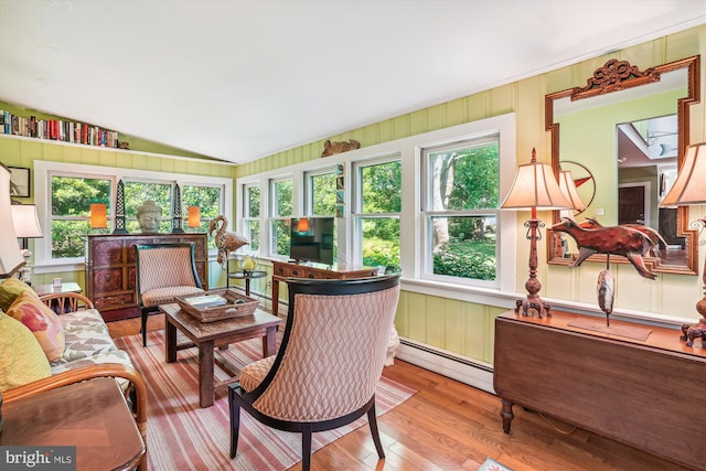 sunroom with vaulted ceiling and a baseboard radiator