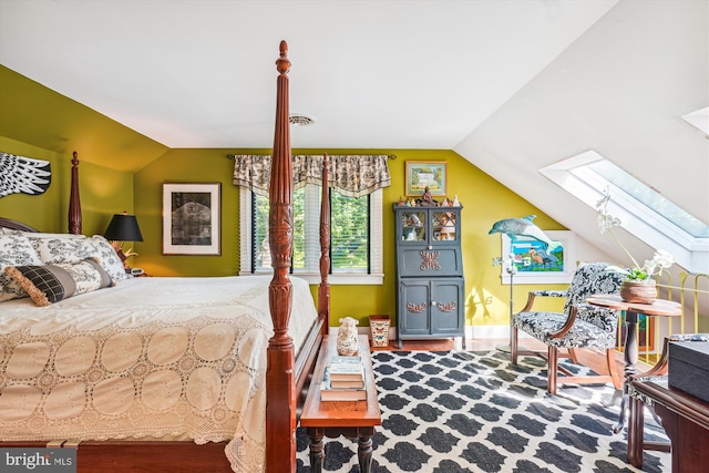 bedroom featuring lofted ceiling with skylight