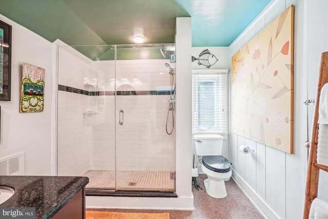 bathroom with toilet, vanity, and walk in shower