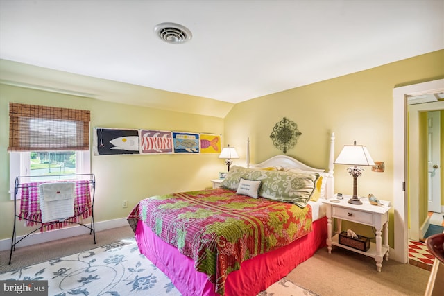 carpeted bedroom featuring vaulted ceiling