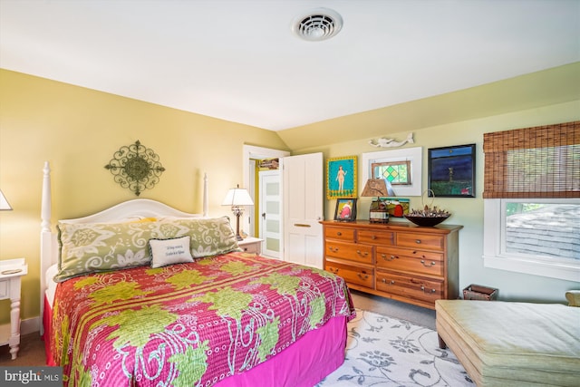 carpeted bedroom featuring vaulted ceiling