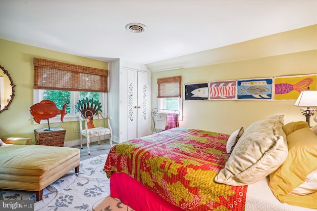 carpeted bedroom with vaulted ceiling