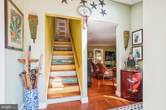 stairway with hardwood / wood-style floors