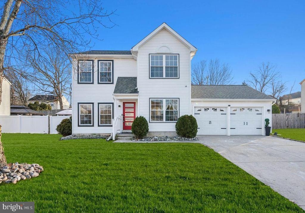 view of front of house featuring a garage and a front lawn