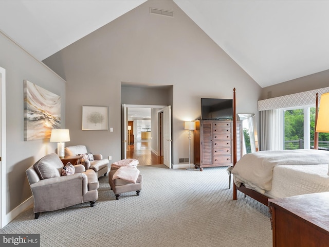 bedroom with high vaulted ceiling and light colored carpet