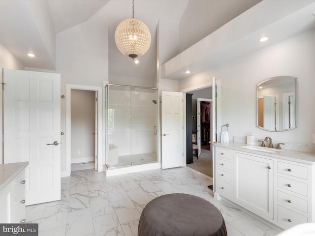 bathroom featuring high vaulted ceiling, vanity, a notable chandelier, and a shower with door