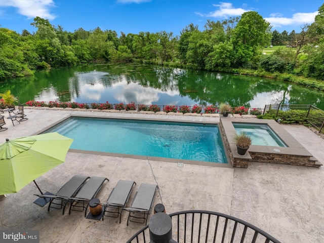 view of swimming pool with a water view, a patio, and an in ground hot tub