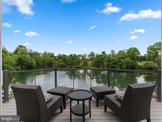 dock area featuring a water view and a balcony