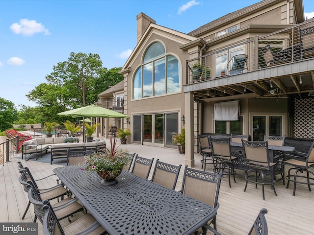 wooden deck with an outdoor living space