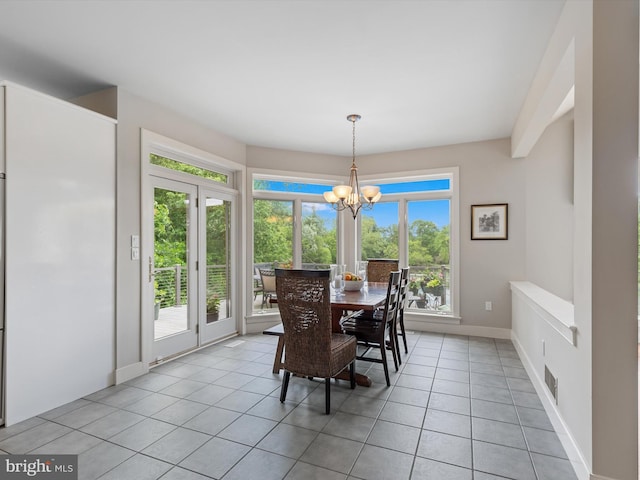 tiled dining space featuring a notable chandelier