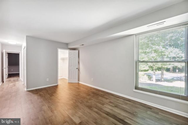 spare room with dark wood-type flooring