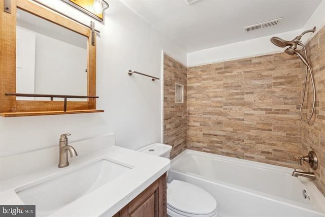 full bathroom featuring toilet, vanity, and tiled shower / bath combo