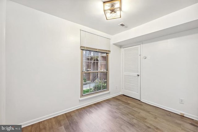 spare room featuring wood-type flooring