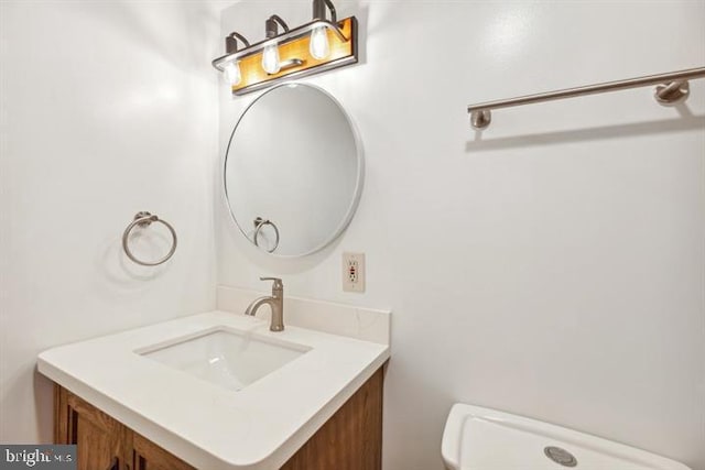 bathroom featuring toilet and vanity