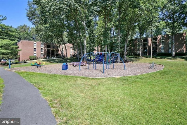 view of playground with a lawn