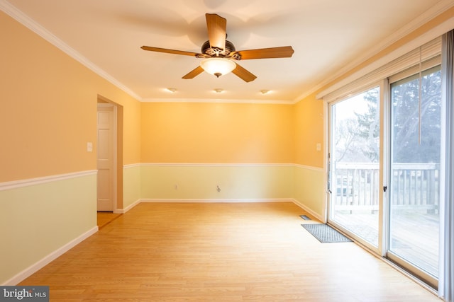 empty room with crown molding, ceiling fan, and light hardwood / wood-style floors