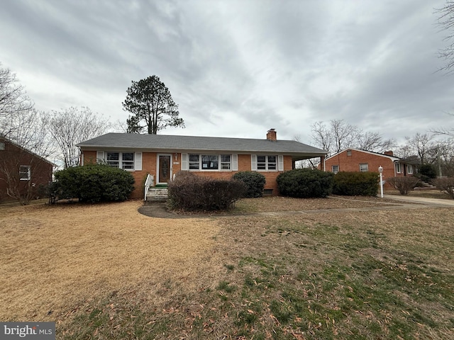 ranch-style home with a front lawn