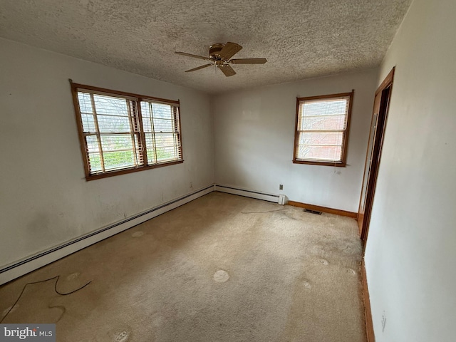 unfurnished room featuring a textured ceiling, ceiling fan, and plenty of natural light