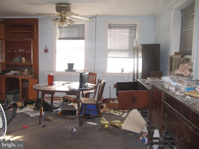 carpeted dining room with ceiling fan