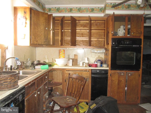 kitchen with sink, black appliances, dark parquet floors, and tasteful backsplash