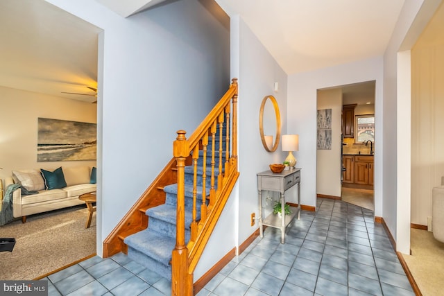 stairway featuring carpet floors and sink