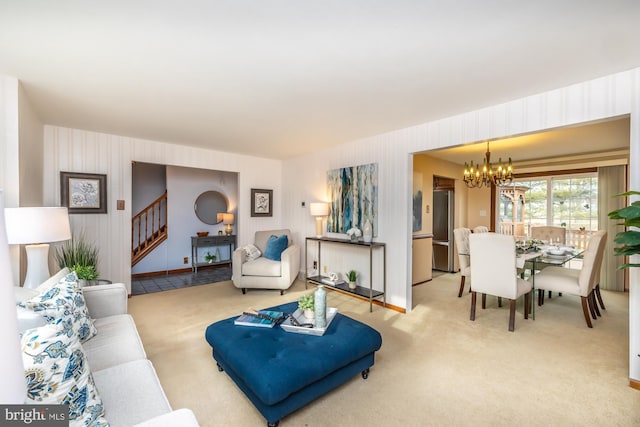 living room featuring carpet floors and a notable chandelier