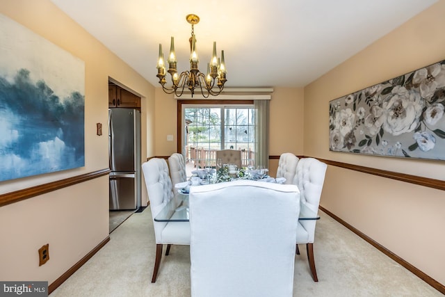 dining area with a chandelier and light carpet