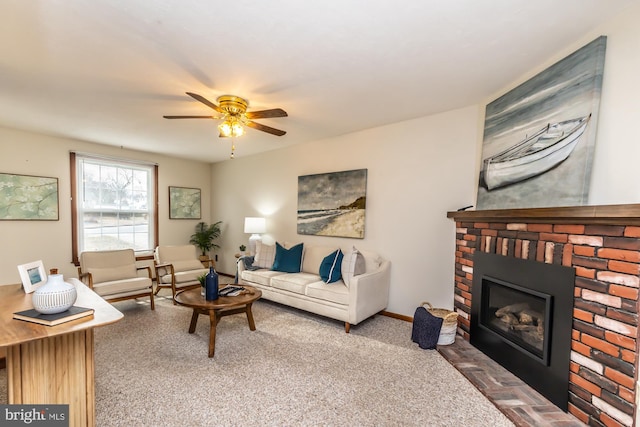 living room with ceiling fan, carpet, and a fireplace