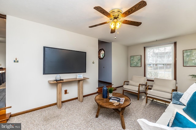 carpeted living room with ceiling fan