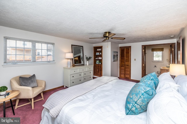 carpeted bedroom featuring ceiling fan, a textured ceiling, and a closet