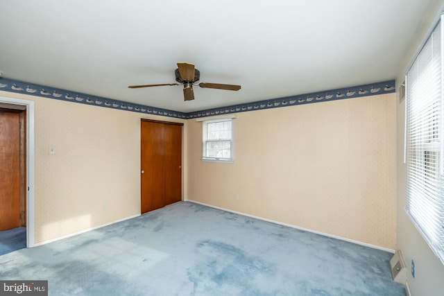 unfurnished bedroom featuring ceiling fan, carpet flooring, and a closet