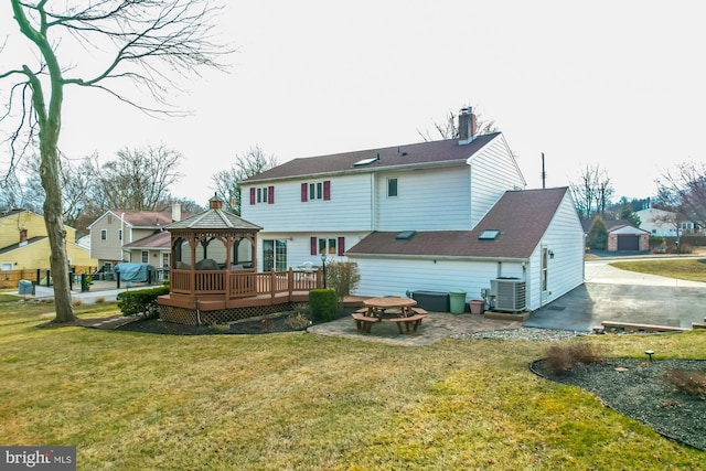 rear view of property with central AC, a gazebo, a lawn, a deck, and a patio