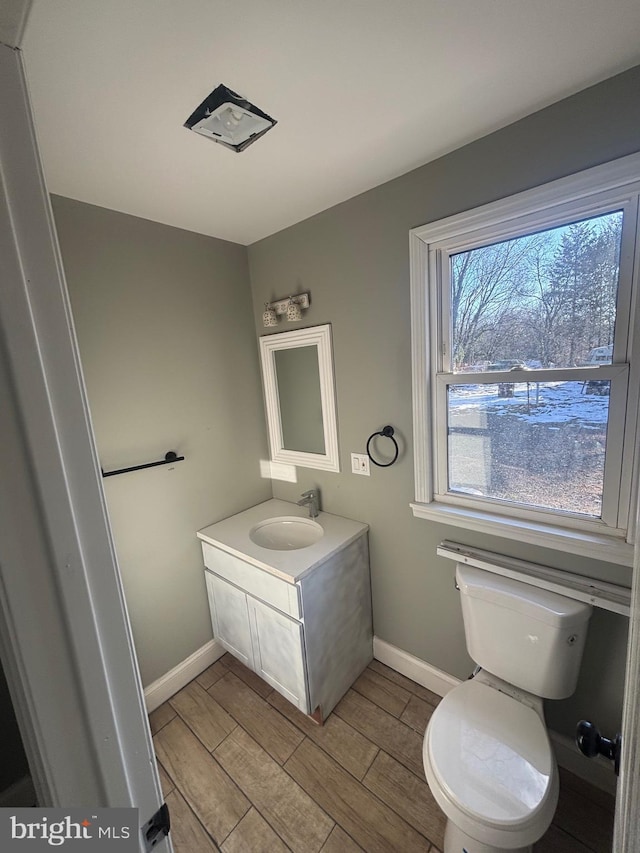 bathroom featuring toilet and vanity