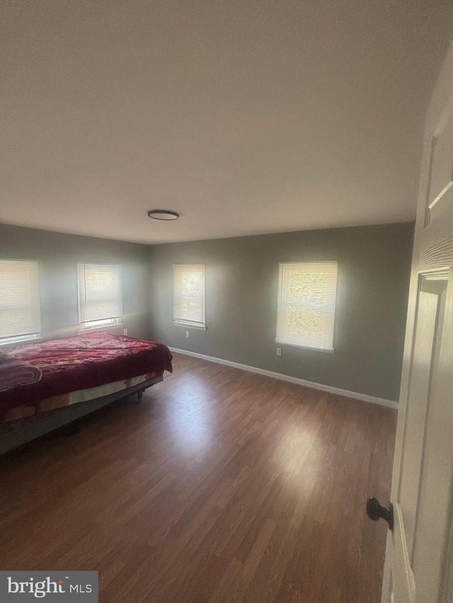 unfurnished bedroom featuring dark wood-type flooring