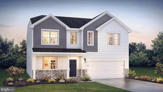 view of front of property featuring a garage and a yard