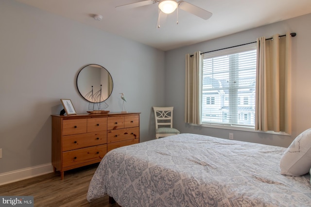 bedroom with hardwood / wood-style floors and ceiling fan