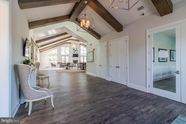 interior space featuring dark wood-type flooring, lofted ceiling with beams, and a notable chandelier