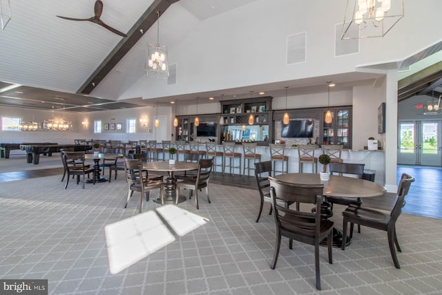 dining room featuring beamed ceiling, high vaulted ceiling, and french doors