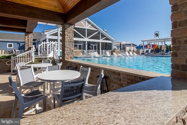 view of pool featuring a pergola and a patio