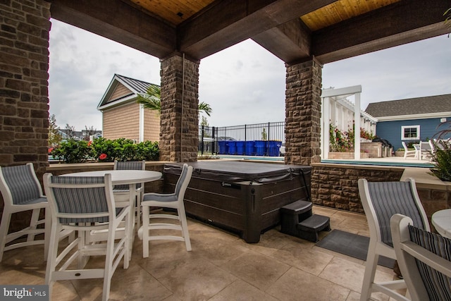 view of patio with a pool with hot tub