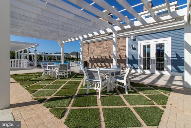 view of patio with a pool, a pergola, and french doors