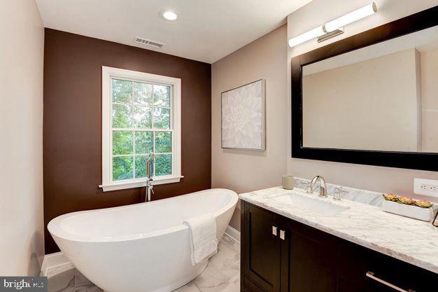 bathroom featuring a tub and vanity